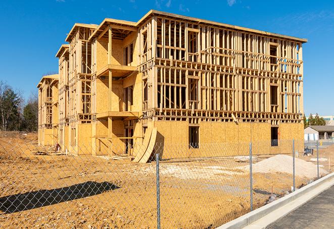 construction zone secured with a temporary fence, marked with warning signs in Roanoke TX